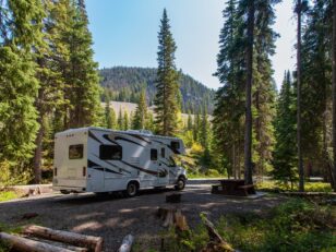 beautiful campsite mountains with rv wooden bench scaled