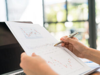 Business woman hand with Financial charts and laptop on the tabl business woman hand with financial charts laptop table