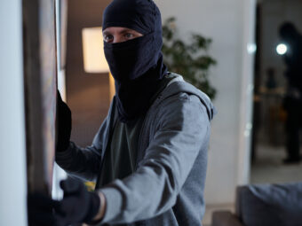 criminal wearing mask stealing painting home burglary