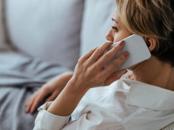 Pensive woman talking on the phone while relaxing on the sofa at distraught woman resting sofa communicating mobile phone scaled