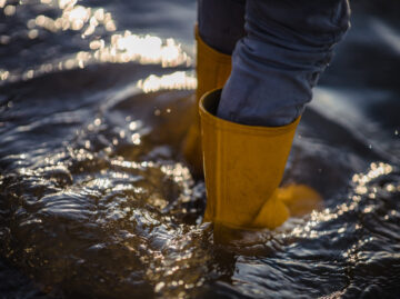 person in blue denim jeans and yellow boots standing on water person blue denim jeans yellow boots standing water 1 scaled