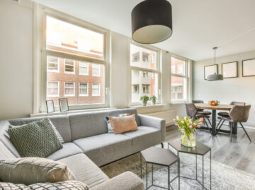 Spacious attic room with sofa and kitchen spacious attic room with sofa kitchen scaled