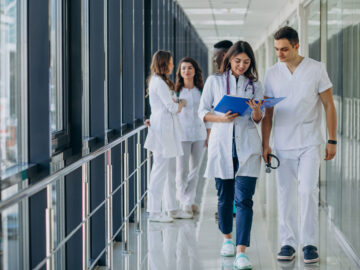 team young specialist doctors standing corridor hospital scaled