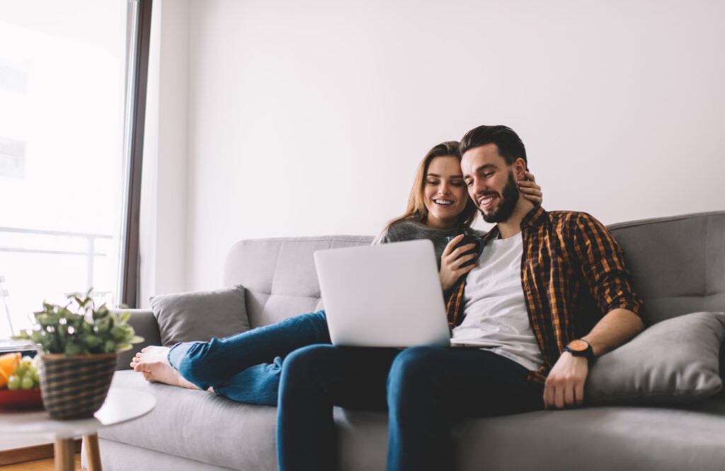 happy couple watching film on laptop 2024 05 23 18 21 36 utc
