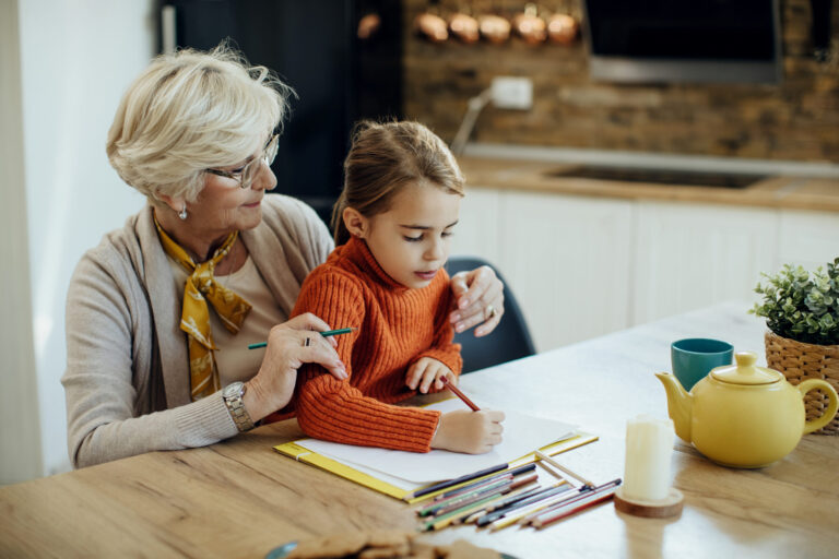 little girl her grandmother enjoying together while drawing paper scaled