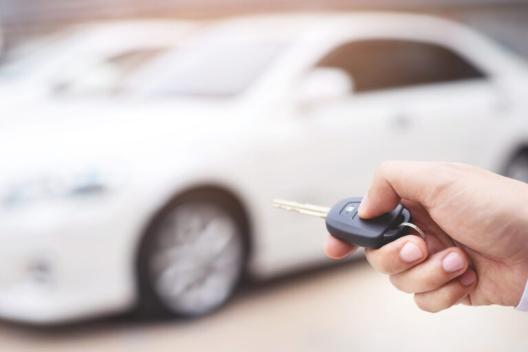 salesman is opening closing car door with key safety scaled