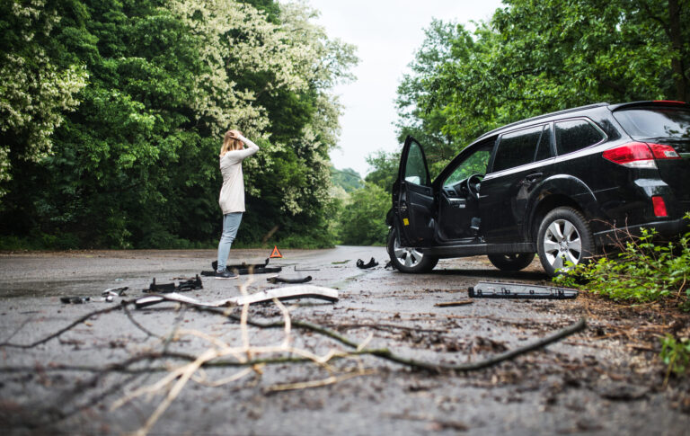 young woman standing by the damaged car after a ca 2024 10 18 09 52 52 utc scaled